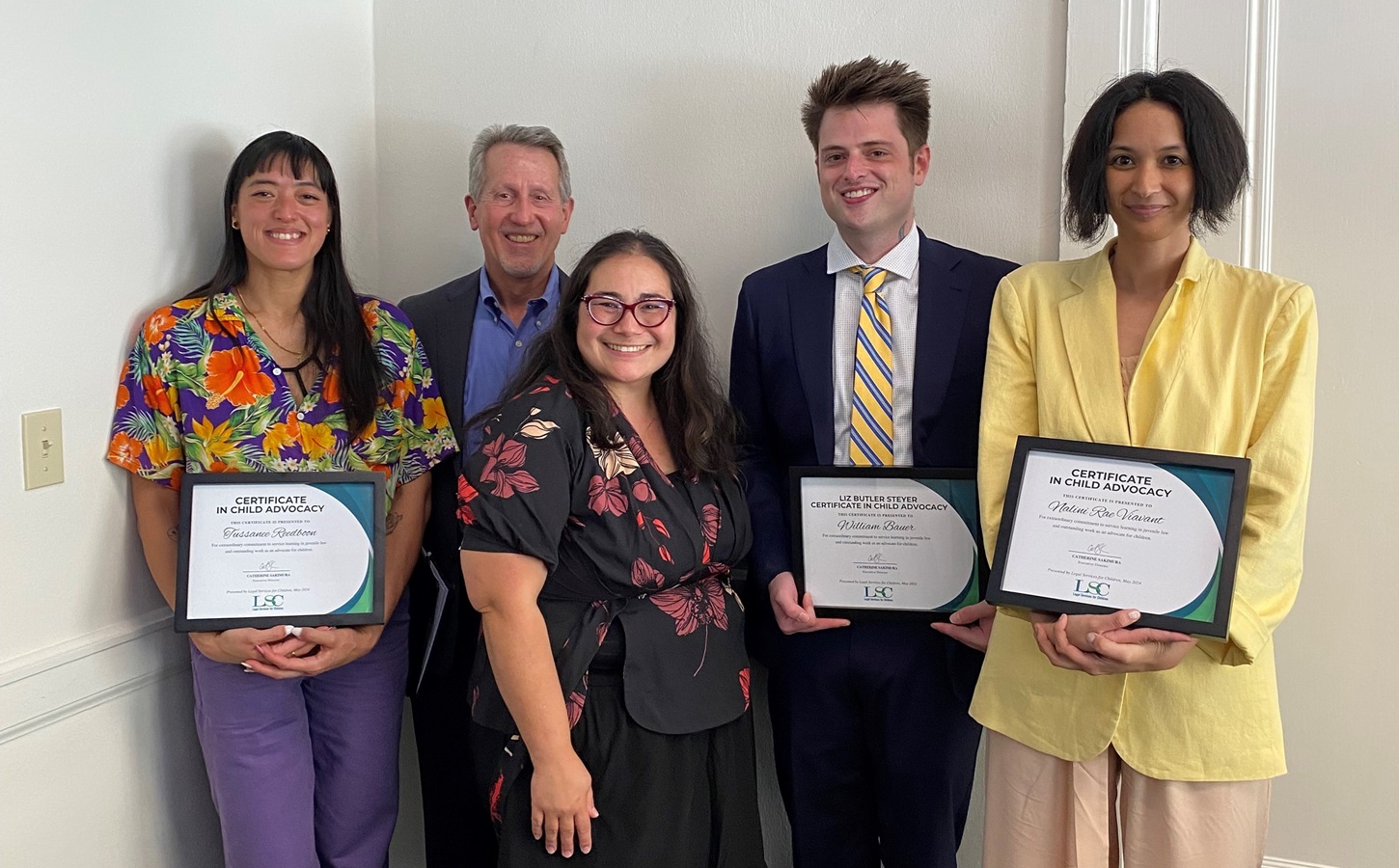 LSC's 2024 Certificate in Child Advocacy Certificate recipients posing with their certificates with LSC's Executive Director Cathy Sakimura and our generous funder Ken from the Bernard E. & Alba Witkin Charitable Foundation