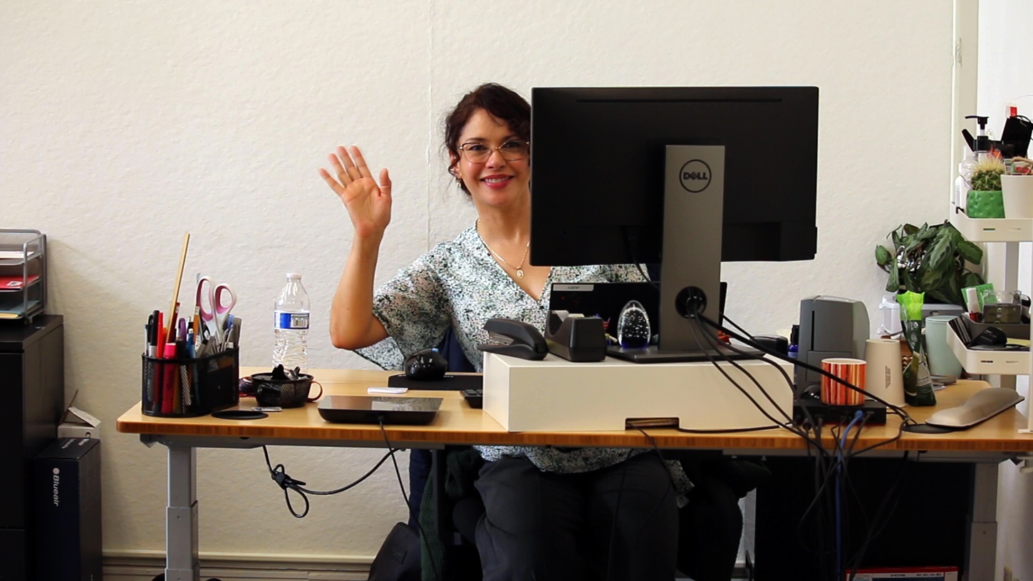 LSC's Administrative Coordinator Judy waving hello from her desk