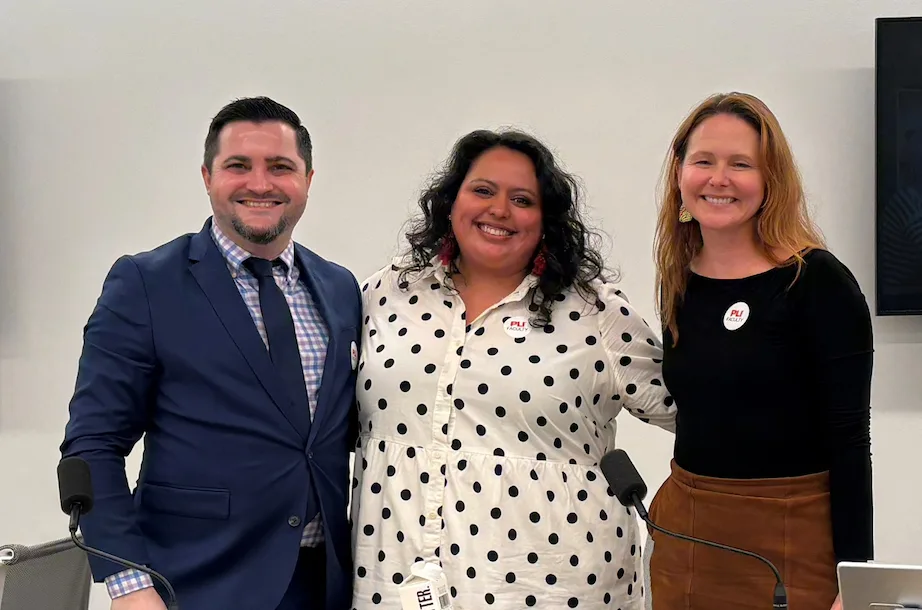 Three panelists standing together. In the center is LSC's Associate Legal Director Stephany Arzaga.