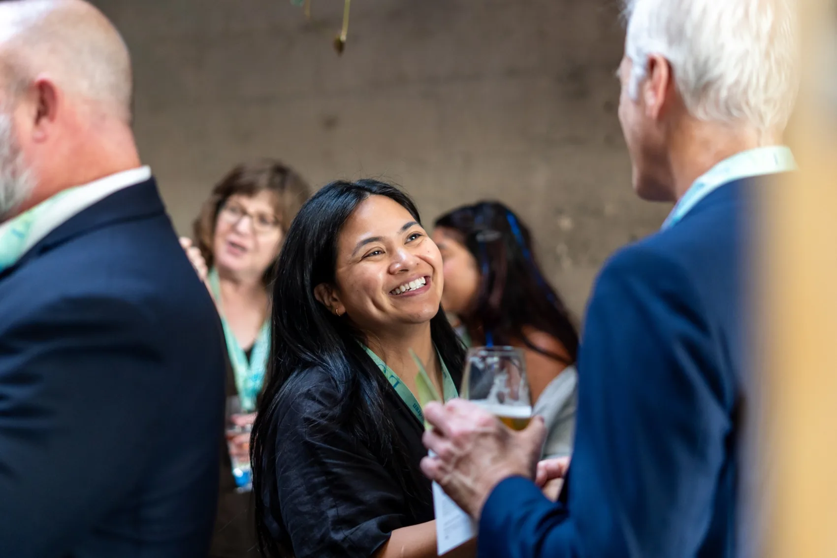 LSC Development Associate Kristine Ortega smiling and greeting an event guest